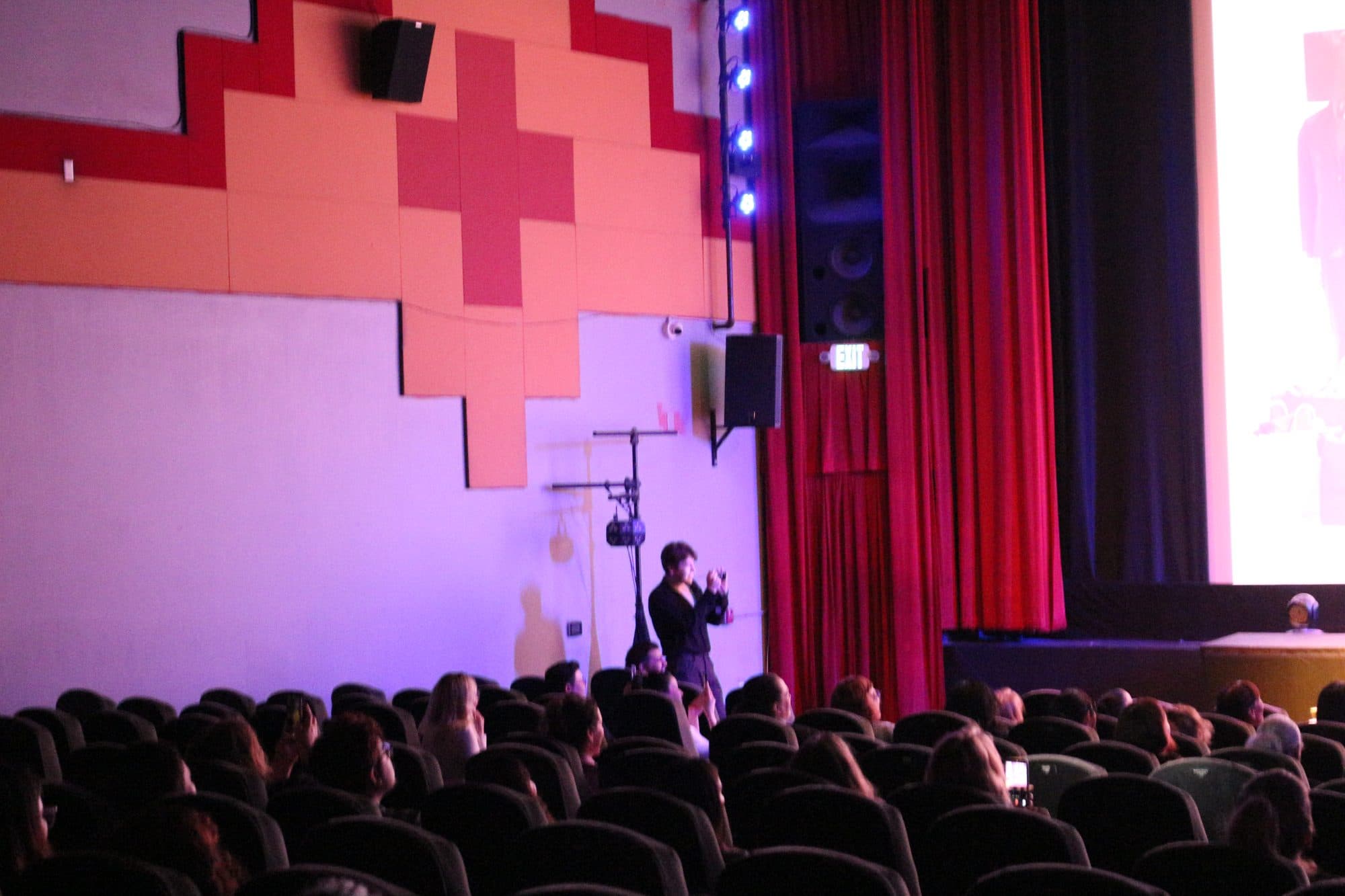 Gregory Ferraro photographing the True Cost screening and fashion show, frame 3