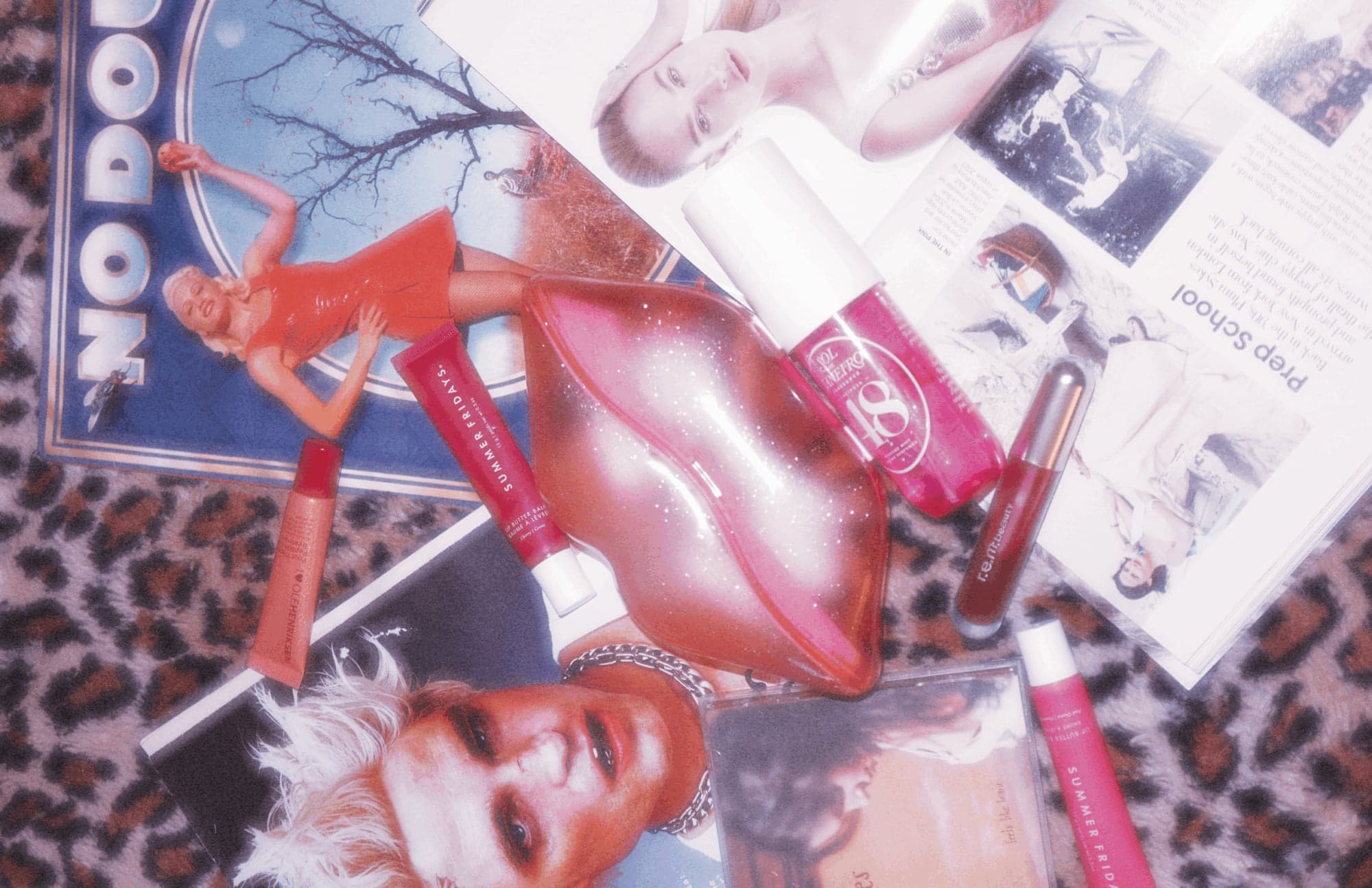 The advice column set: magazines, lipstick and a lip phone on leopard print