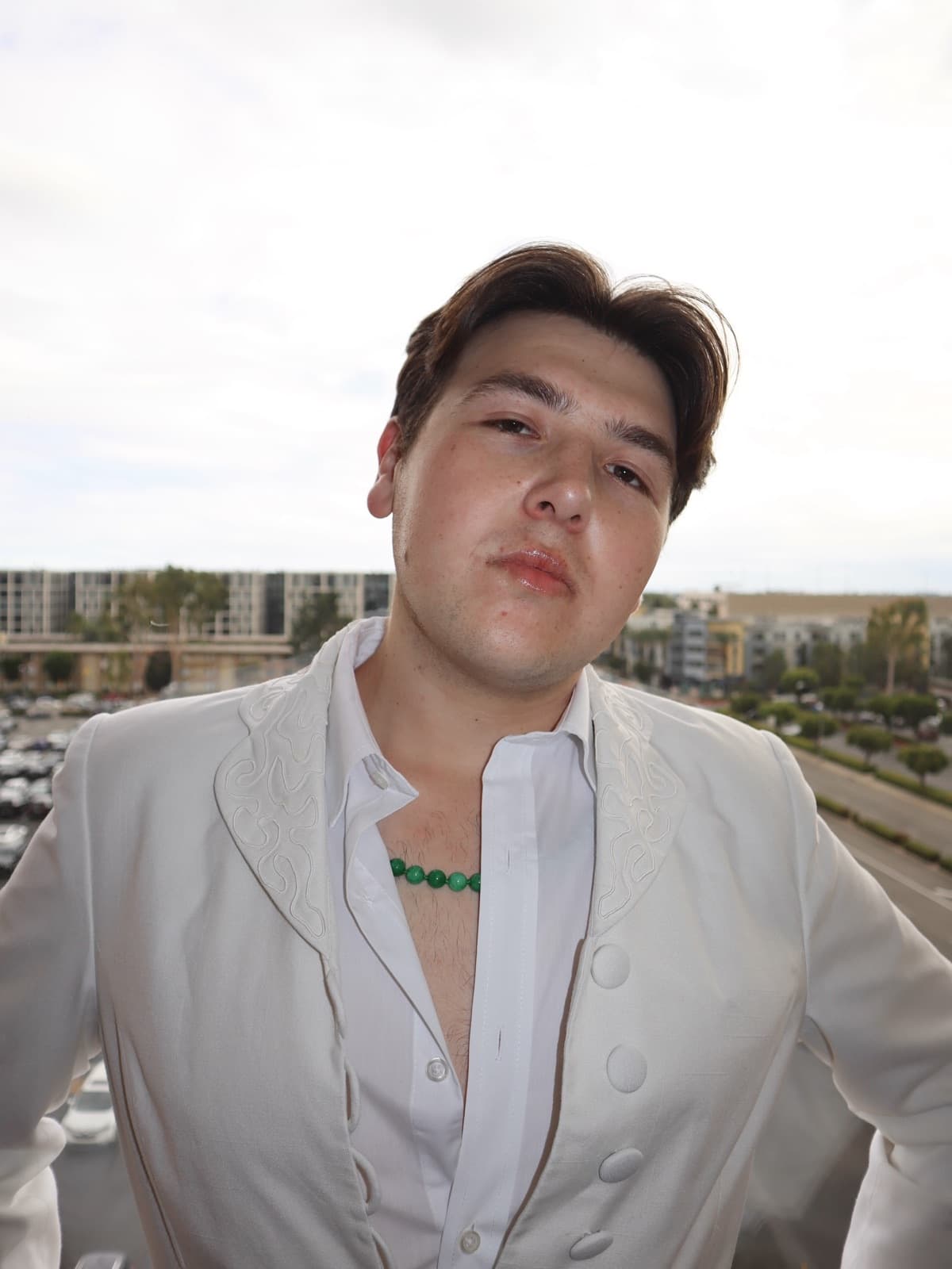 Gregory Ferraro in a white suit, graduation portrait · 11