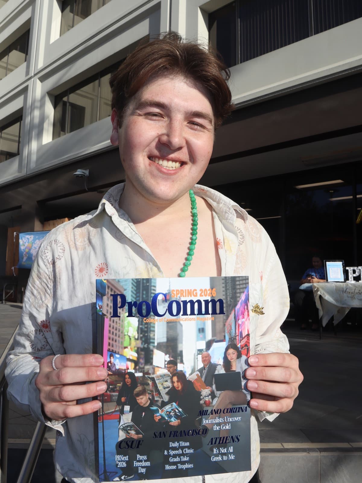Gregory Ferraro with ProComm Magazine’s spring 2026 issue at its launch